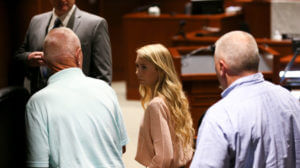 Doctor says young woman in murder trial said she buried baby