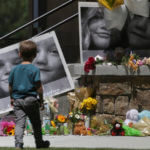 A boy checks out a memorial for Tylee Ryan, 17, and Joshua "JJ" Vallow