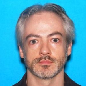Professor charged in stabbing death blames another man