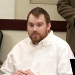 Travis Reinking sits in court