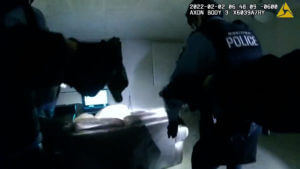 Police video shows man shot by officer was on couch, had gun
