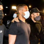 Jussie Smollett walks outside in a facemask