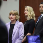 Actor Amber Heard stands with her lawyers Elaine Bredehoft and Benjamin Rottenborn