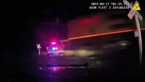 2 officers, detainee charged in case of patrol vehicle hit by train