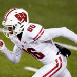 A football player runs on the field