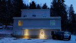 police officer stands guard in his vehicle at the home where four University of Idaho students were found dead