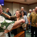 Albert "Ian" Schweitzer, left, hugs his mother, Linda, moments after a judge ordered him released from prison