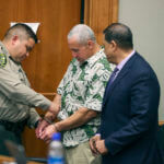 A court officer removes Albert "Ian" Schweitzer's handcuffs