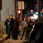 Investigators gather at a scene where a shooting took place in Monterey Park