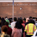 Students and police gather outside of Richneck Elementary