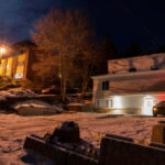 A private security officer sits in a vehicle, Tuesday, Jan. 3, 2023, in front of the house in Moscow, Idaho where four University of Idaho students were killed