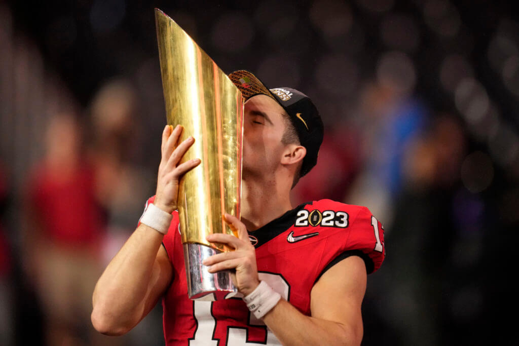Georgia quarterback Stetson Bennett (13) kisses the championship trophy after the national championship