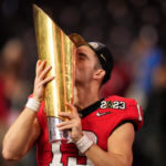 Georgia quarterback Stetson Bennett (13) kisses the championship trophy after the national championship