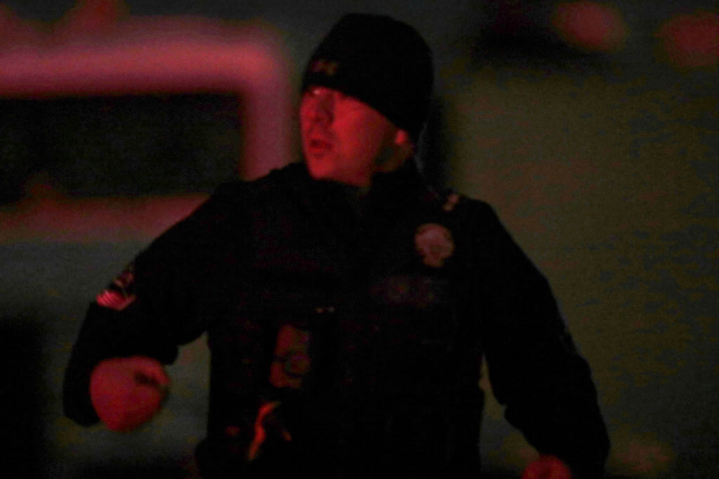 A law enforcement officer stands stands near the Enoch, Utah, home where eight family members were found dead