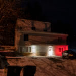 A private security officer sits in a vehicle, Tuesday, Jan. 3, 2023, in front of the house in Moscow, Idaho where four University of Idaho students were killed