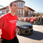 Stetson Bennett walks the route during a parade