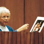 Louise Ireland gestures towards a color enlargement, the last taken of her daughter, Dana Ireland