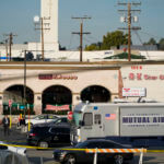 Investigators are seen outside Star Dance Studio in Monterey Park, Calif., Sunday, Jan. 22, 2023
