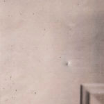 Close up white door with pellet defect
