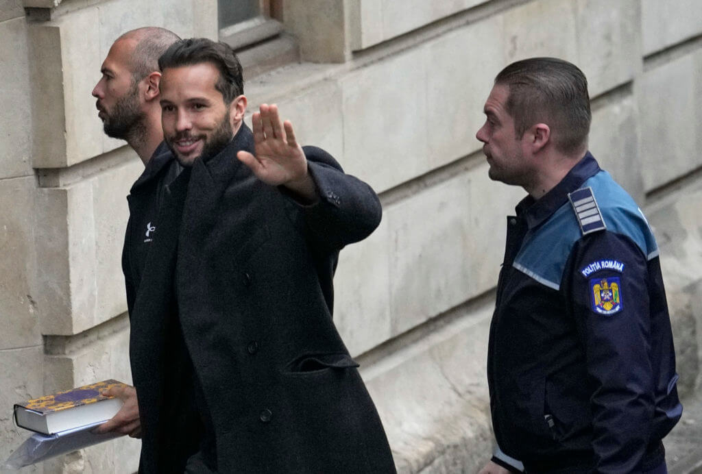 Andrew Tate and his brother Tristan are brought by police officers to the Court of Appeal, in Bucharest, Romania