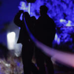 A law enforcement officer stands stands near the Enoch, Utah, home where eight family members were found dead