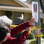 Rosa Maria Perez, with her granddaughter Abigail Gil, pay their respects to Bishop David O'Connell