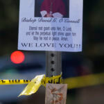 An image of Bishop David O'Connell is posted on the post of a street sign near his home