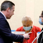 Chunli Zhao, center, appears for a plea hearing with his defense attorney Eric Hove