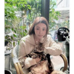 model Abby Choi, holding a cat, poses for a photo on Feb. 11, 2023, in Hong Kong