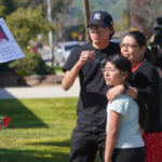 Gabriela Gil and her children pay their respects to Bishop David O'Connell
