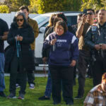 Neighbors and parishioners pray the rosary for Bishop David O'Connell