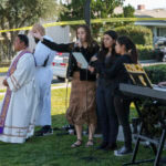The Rev. Albert Avenido, left, and sacristan Hector Ibarra lead members of Sacred Heart Catholic Church in Covina, Calif., on a prayer vigil for Bishop David O'Connell