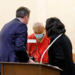 Chunli Zhao, center, appears for a plea hearing with his defense attorney Eric Hove