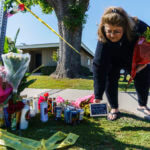 Ramona Torres brings flowers and a framed message to pay her respects to Bishop David O'Connell