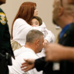 Alexis Bailey, one of the sisters of Tristyn Bailey, gets a hug from one of Tristyn's friends