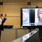 Assistant state attorney speaks next to a monitor with a photo in it.