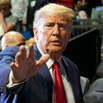 Former President Donald J. Trump waves as he arrives for the NCAA Wrestling Championships