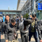 olice escort a suspect at the Shenzhen Bay Port border crossing in Hong Kong