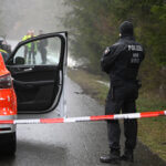 Police forces stand at a cordon near in Freudenberg