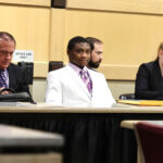 Suspects in the XXXTentacion murder trial sit with their attorneys.