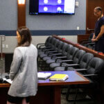 Nathan Chasing Horse and his public defender during a court hearing.