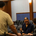 Nathan Chasing Horse speaks with his public defender on April 3, 2023.