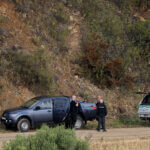 Police officers talk near an operation site near Barragem do Arade