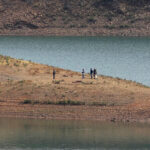 Police work on the banks of the Arade dam