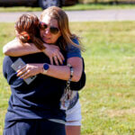 Ashleigh Webster hugs family friend Shannon Dillon
