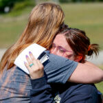 Ashleigh Webster hugs family friend Shannon Dillon