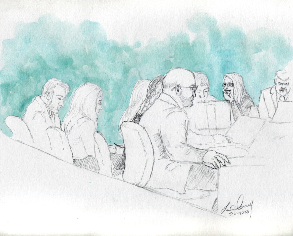 Lori and her attorneys listen to jury instructions