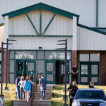 Law enforcement stand outside of Henryetta High