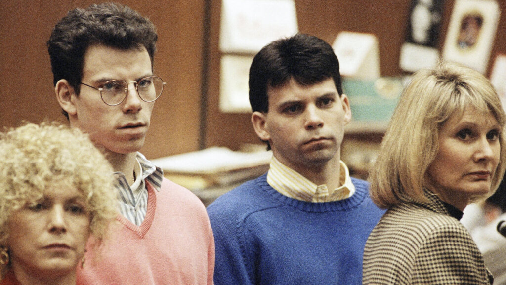 Lyle Menendez, right, and brother Erik listen to a charge of murder conspiracy against them