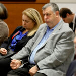 Tony and Jennifer Montalto hold hands during closing arguments in the trial of former School Resource Officer Scot Peterson.